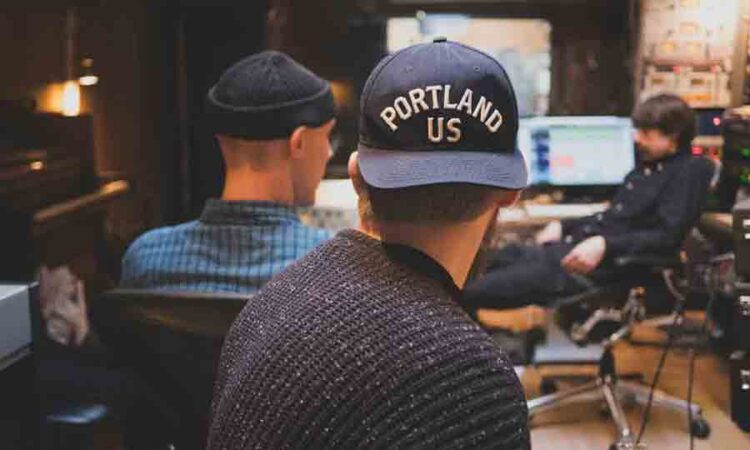 Happy stylish hipster man using technology
