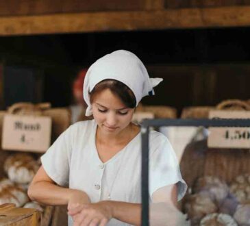 Young Woman Chef Serving Fresh Salad at Kitchen