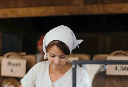 Young Woman Chef Serving Fresh Salad at Kitchen