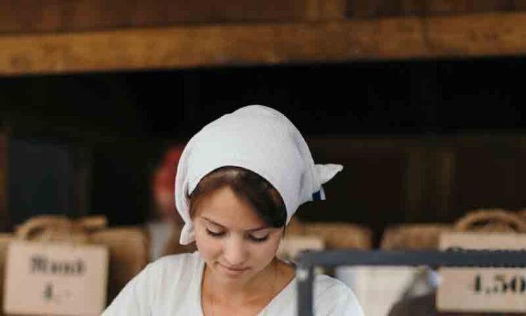 Young Woman Chef Serving Fresh Salad at Kitchen